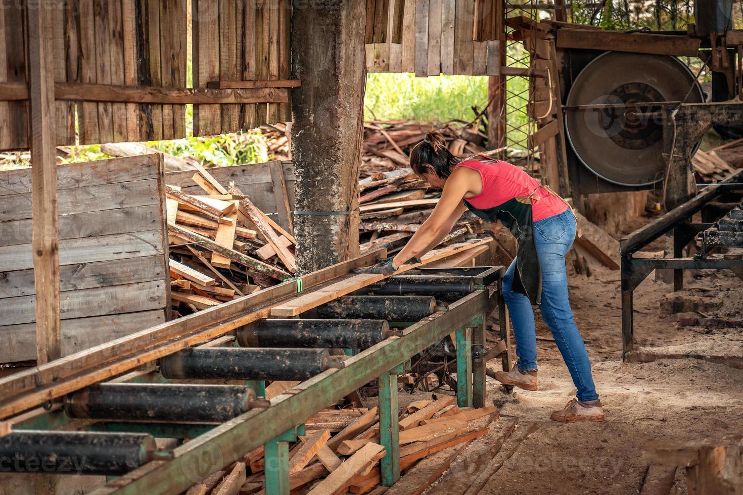 Portrait of adult industrial woman working in a wood shop. photo