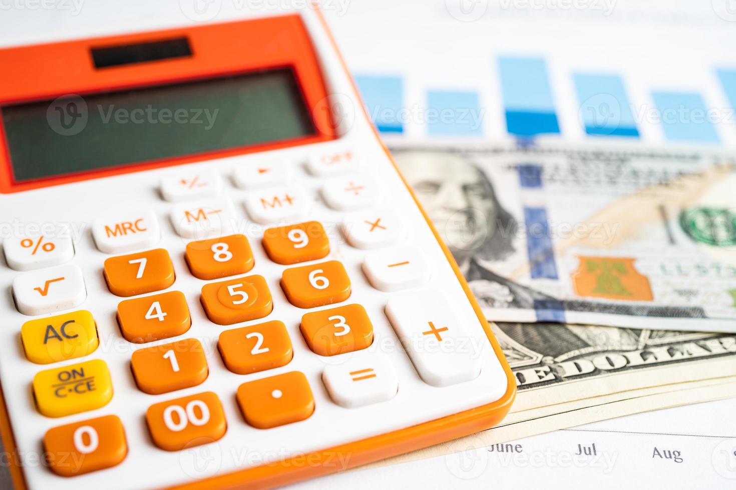 Pen and calculator on chart or graph paper. Financial, account, statistics and business data concept. photo