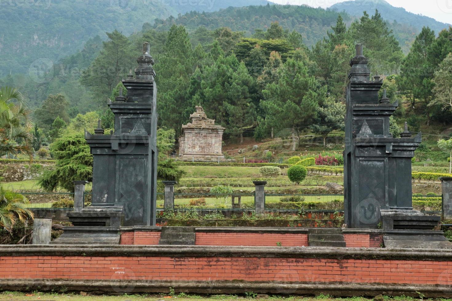 The gate of the Gedong Songo temple with the background of the first temple, located in Semarang district, Central Java photo