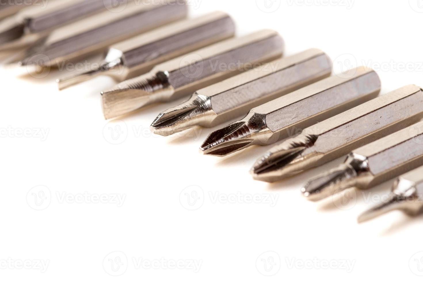 A set of different attachments for a head screwdriver with a screwdriver on a white background photo