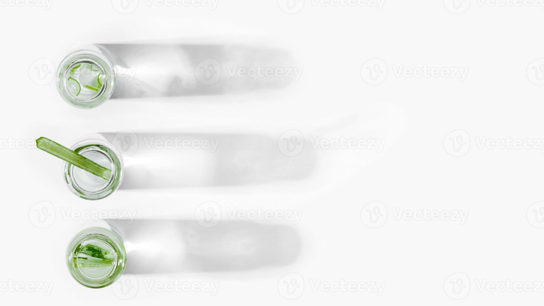 organic cosmetics, natural cosmetics, biofuels, algae. Natural green laboratory. Experiments. Laboratory glass jars in a row with green plants on a light background. photo
