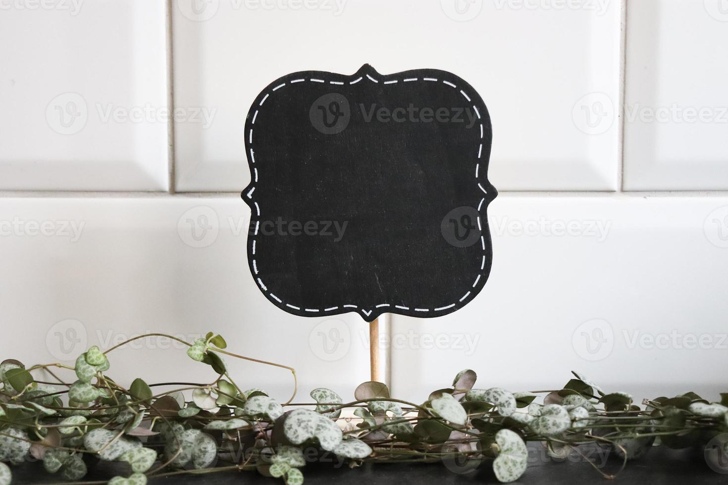 Chalkboard sign mockup with white tiles photo