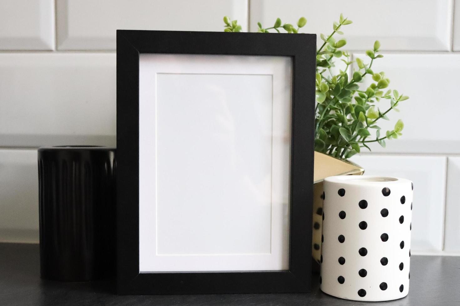 Black frame mockup with monochrome candle photo