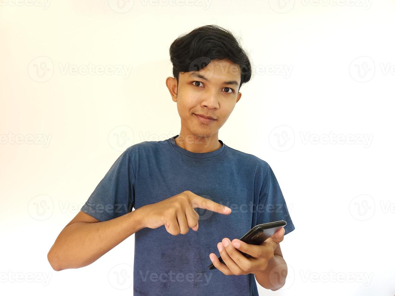 Happy smile face Asian man playing on his phone, pointed smartphone photo