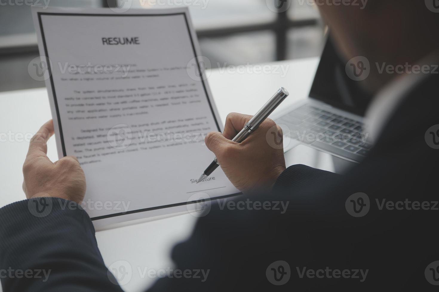Close up view of job interview in office, focus on resume writing tips, employer reviewing good cv of prepared skilled applicant, recruiter considering application, hr manager making hiring decision photo