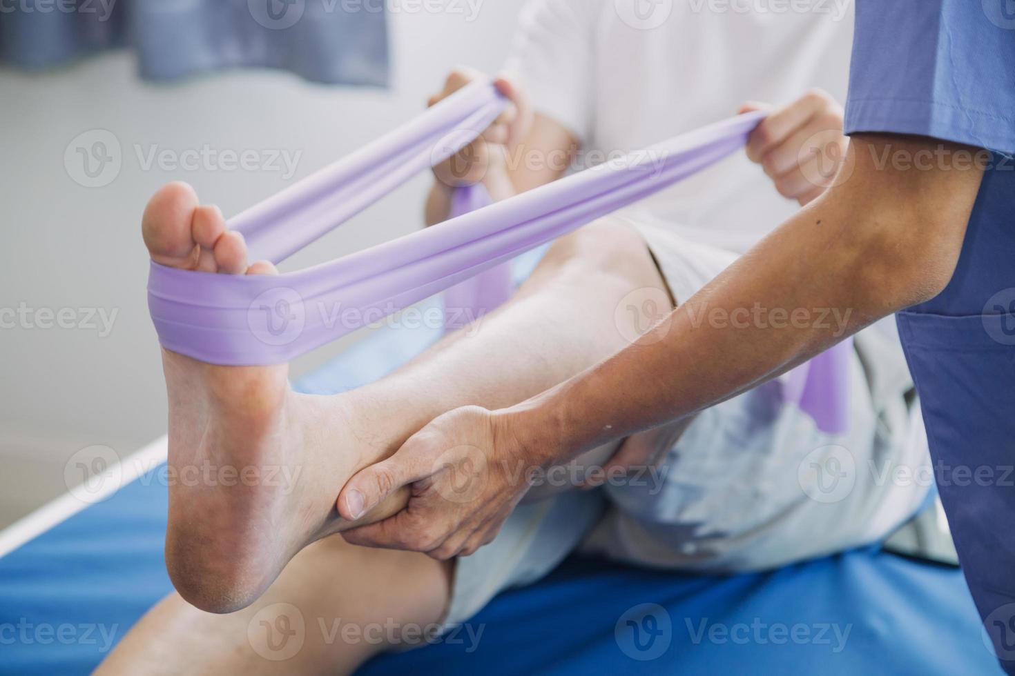 Doctor or Physiotherapist working examining treating injured arm of athlete male patient, stretching and exercise, Doing the Rehabilitation therapy pain in clinic. photo