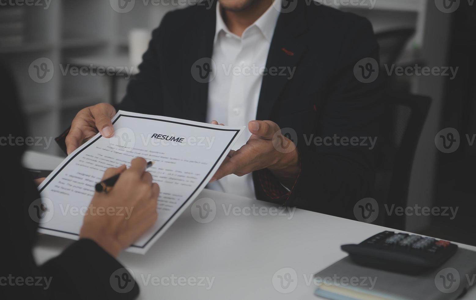 Close up view of job interview in office, focus on resume writing tips, employer reviewing good cv of prepared skilled applicant, recruiter considering application, hr manager making hiring decision photo
