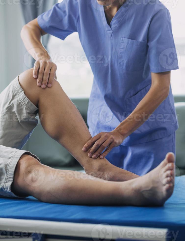 Doctor or Physiotherapist working examining treating injured arm of athlete male patient, stretching and exercise, Doing the Rehabilitation therapy pain in clinic. photo