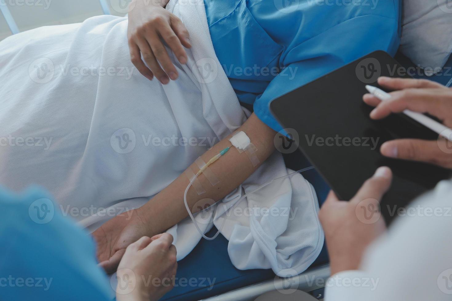 Women Asian doctors hold the patient hand and encourage and provide medical advice While checking the patient health in bed. Concept of Care and compassion, antenatal care, Threatened abortion photo