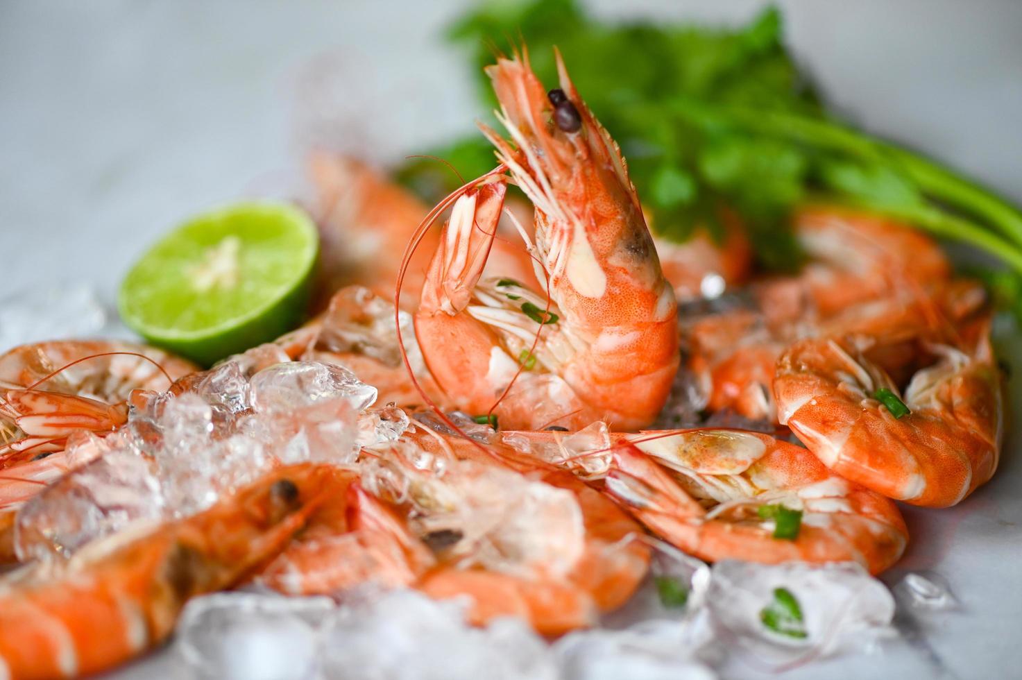 shrimp on white plate background dining table food, Fresh shrimps prawns seafood lemon lime with herbs and spice photo