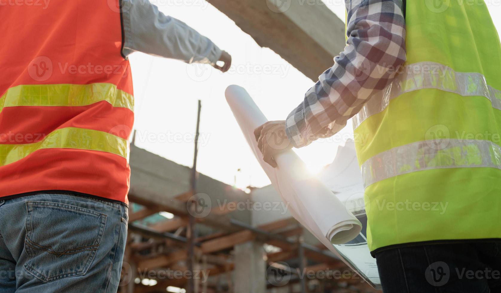 inspector or engineer is inspecting construction and quality assurance new house using a blue print. Engineer or architects or contactor work to build the house before handing it over to the homeowner photo