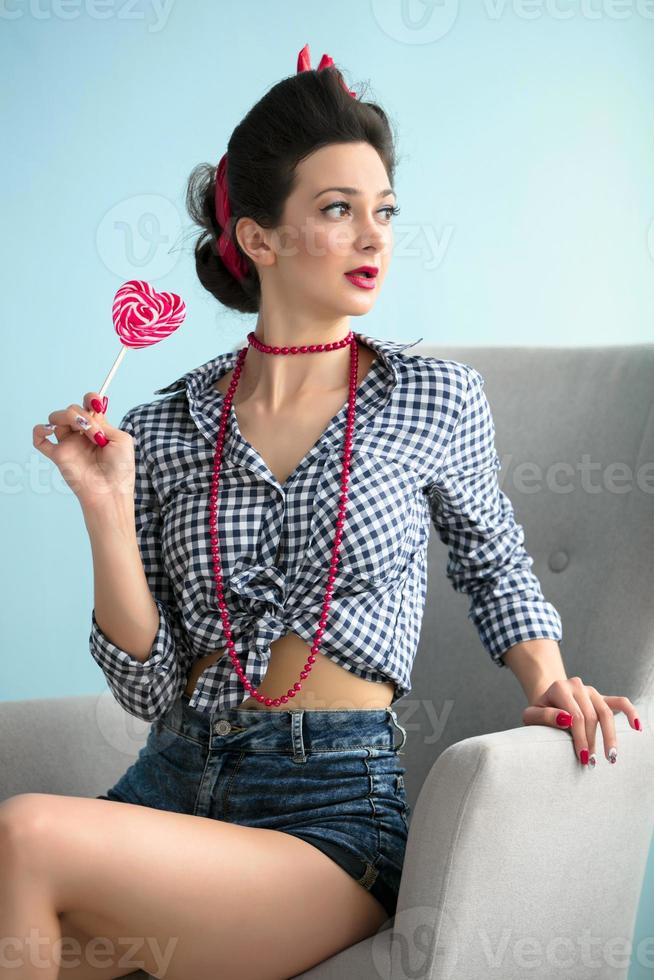 Retro girl in the style of the fifties with candy photo
