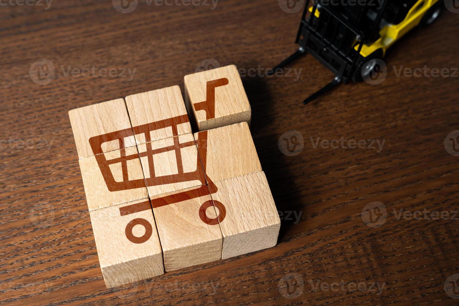 A forklift picks up goods in a shopping cart. The concept of organizing retail trade and delivery logistics. Big sale. Best special offers on market. Marketing, loyalty programs and discounts. photo