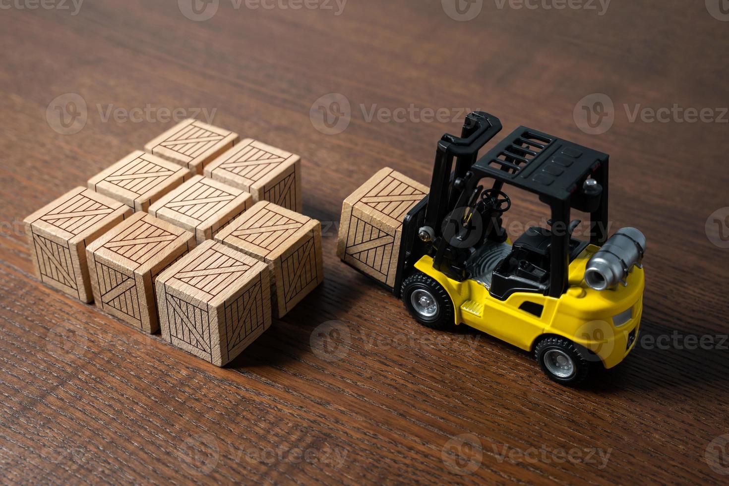 A forklift transports and places boxes. Order for shipment. Production and freight of goods. Increase in imports and exports. The work of the transport department of the enterprise. photo