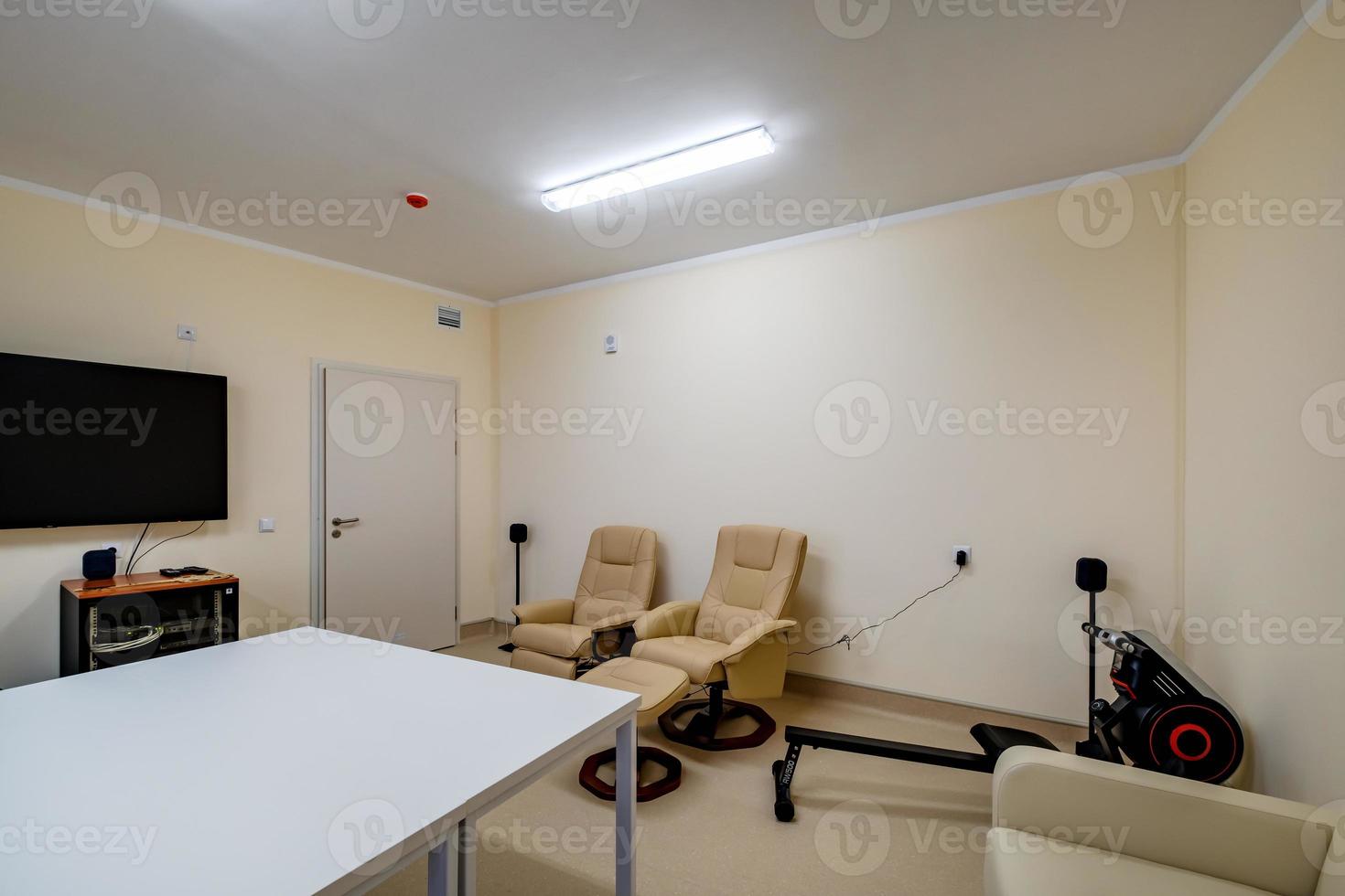 relaxation room with chairs and exercise equipment in office for rest and relax of staff photo