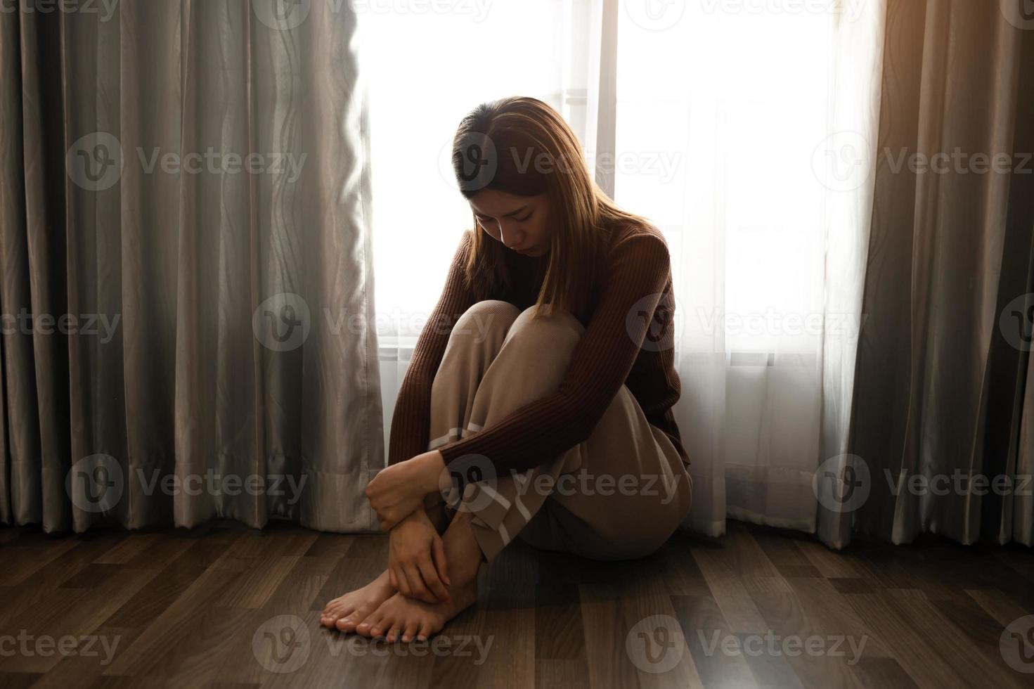 woman sit Depression Standing by window and anxiety Copy space. photo