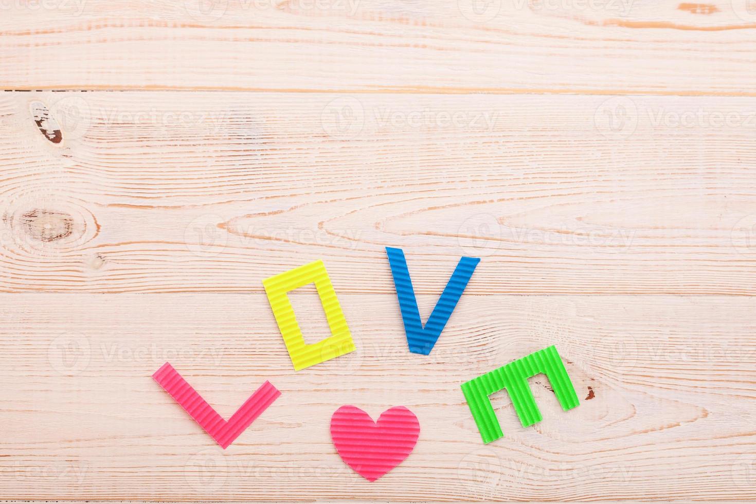 Word love on blue wooden background. Top view photo