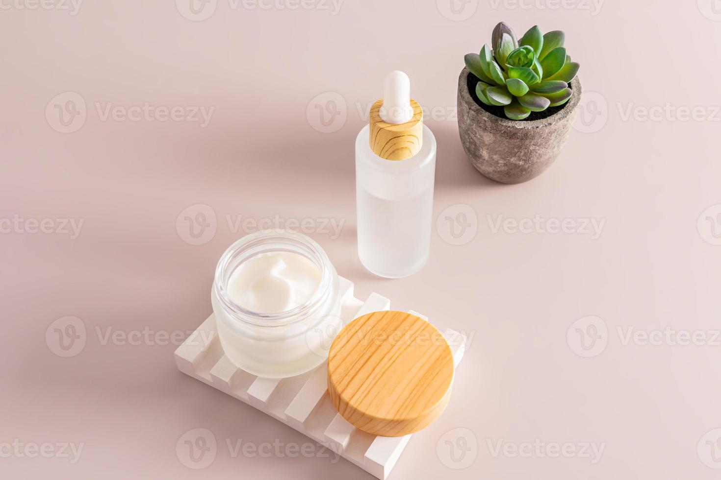 an open matte jar with moisturizer on a plaster relief podium and serum in a white matte bottle on a beige background. cosmetic care. photo
