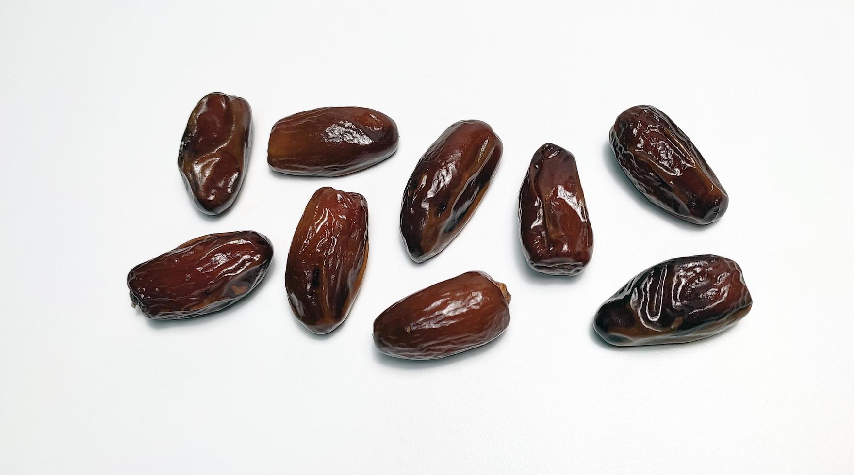 Close up of dried dates fruit isolated on white background photo