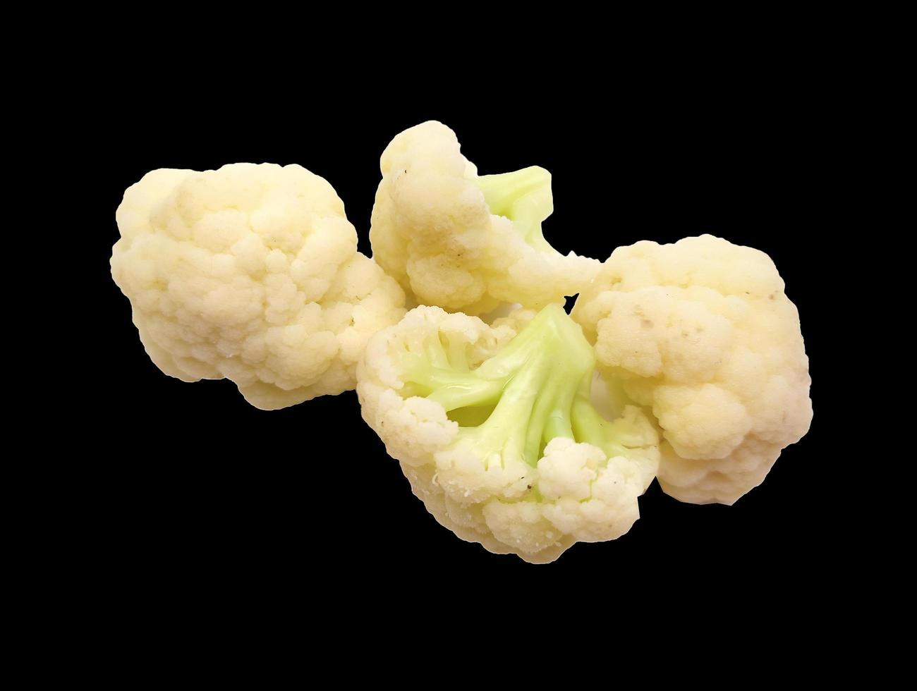 cauliflower pieces isolated in black background photo