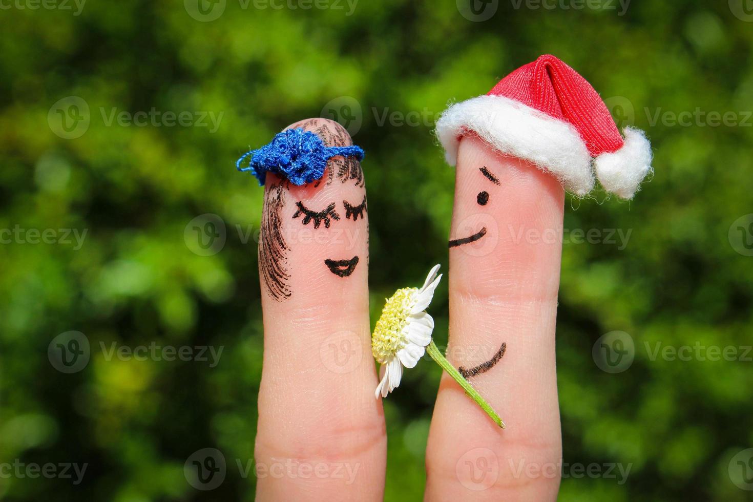 Finger art of Happy couple. Man is giving flowers to woman photo