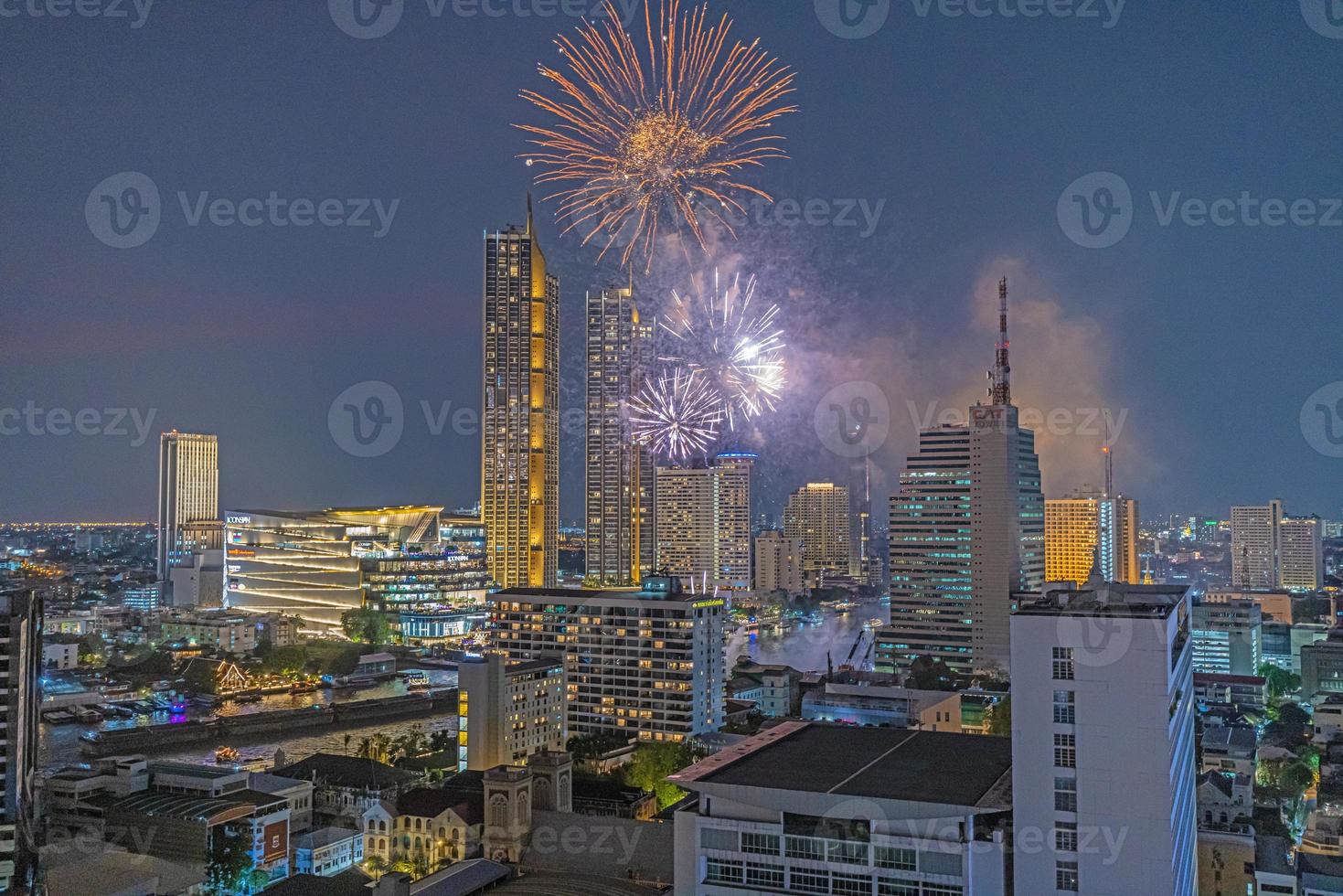 Aerial view of a fireworks display over the Chao Phraya River in Bangkok photo