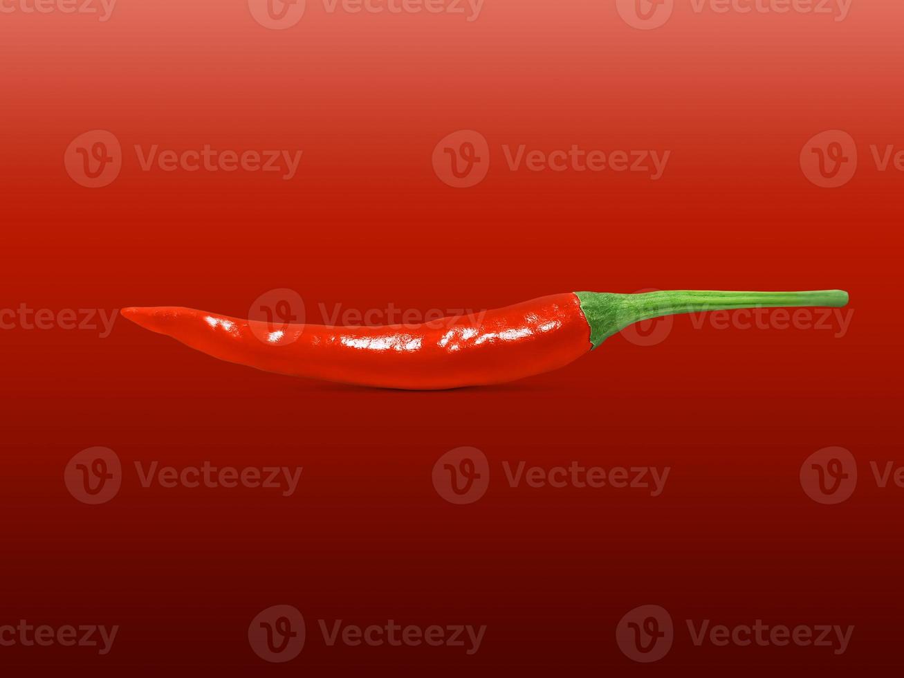 Fresh red pepper isolated on red background photo