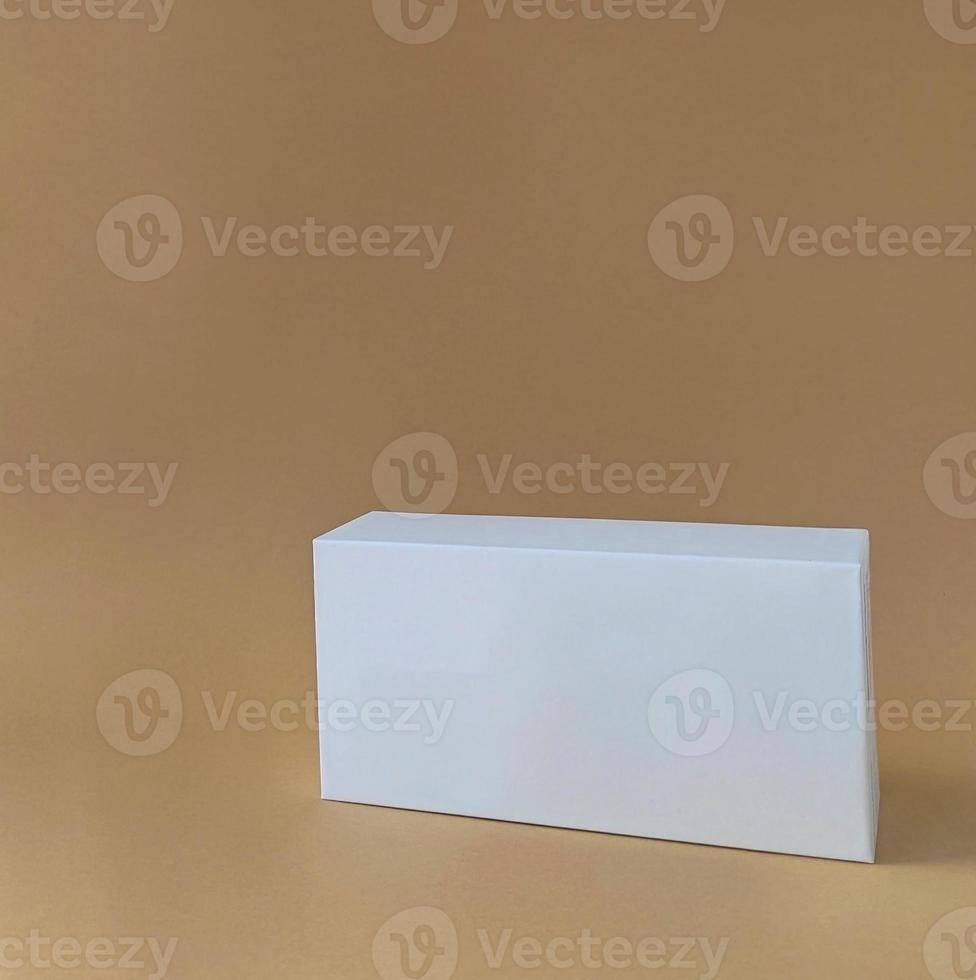 White box on a pastel background for mock-up, front view. Trendy product stand display showcase for cosmetic products and goods. Copy space. photo