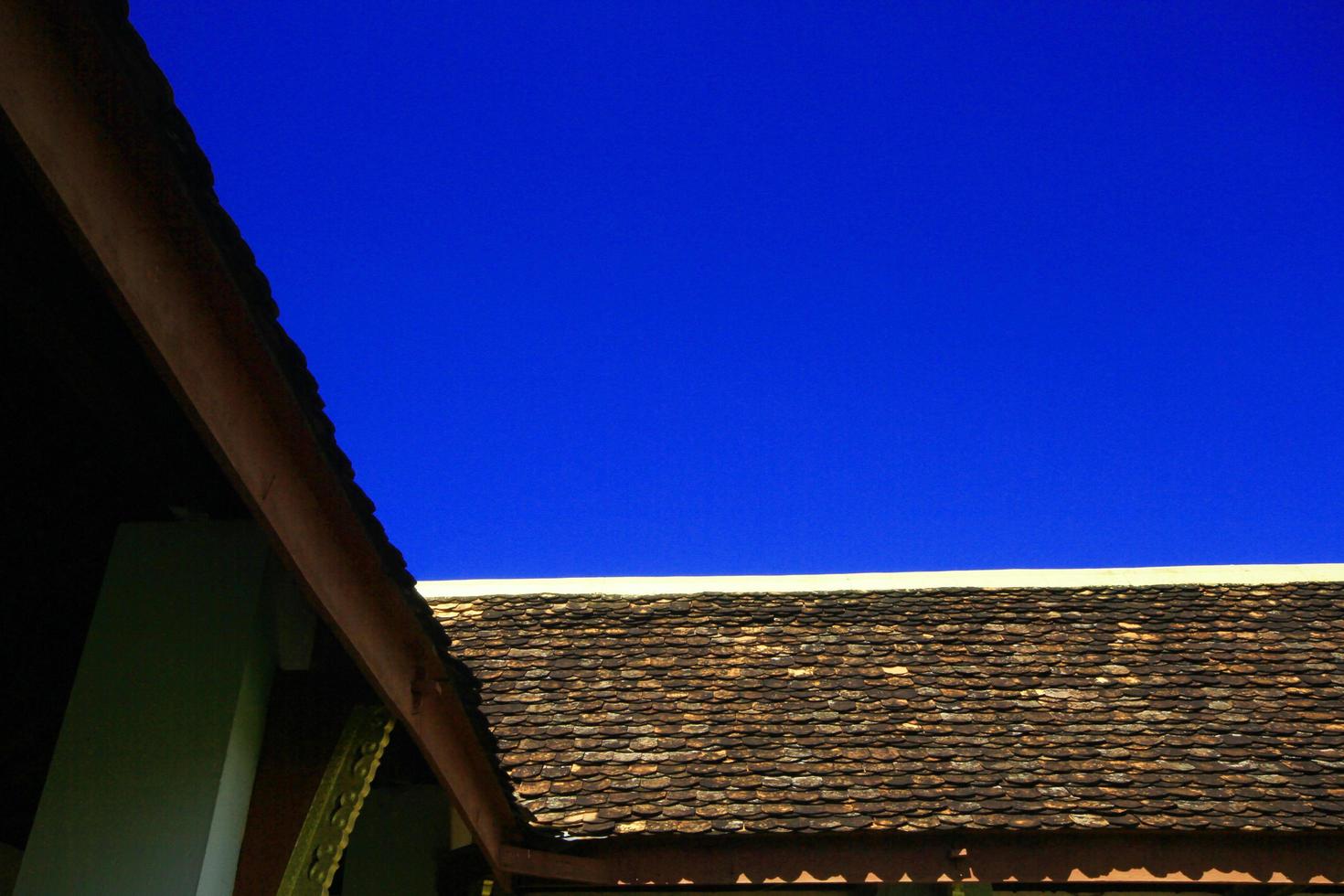 Clay tile Art Roof of Buddhist temple in blue sky photo