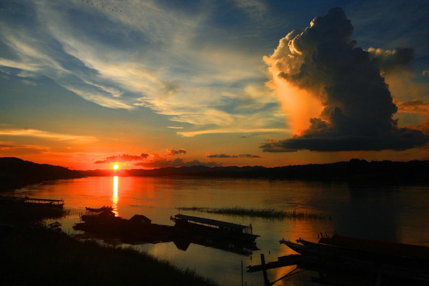 Tradition of Long tail boat and fisherman in beautiful sunset twilight at Khong river the Thai-Laos border Chaingkhan distric Thailand photo