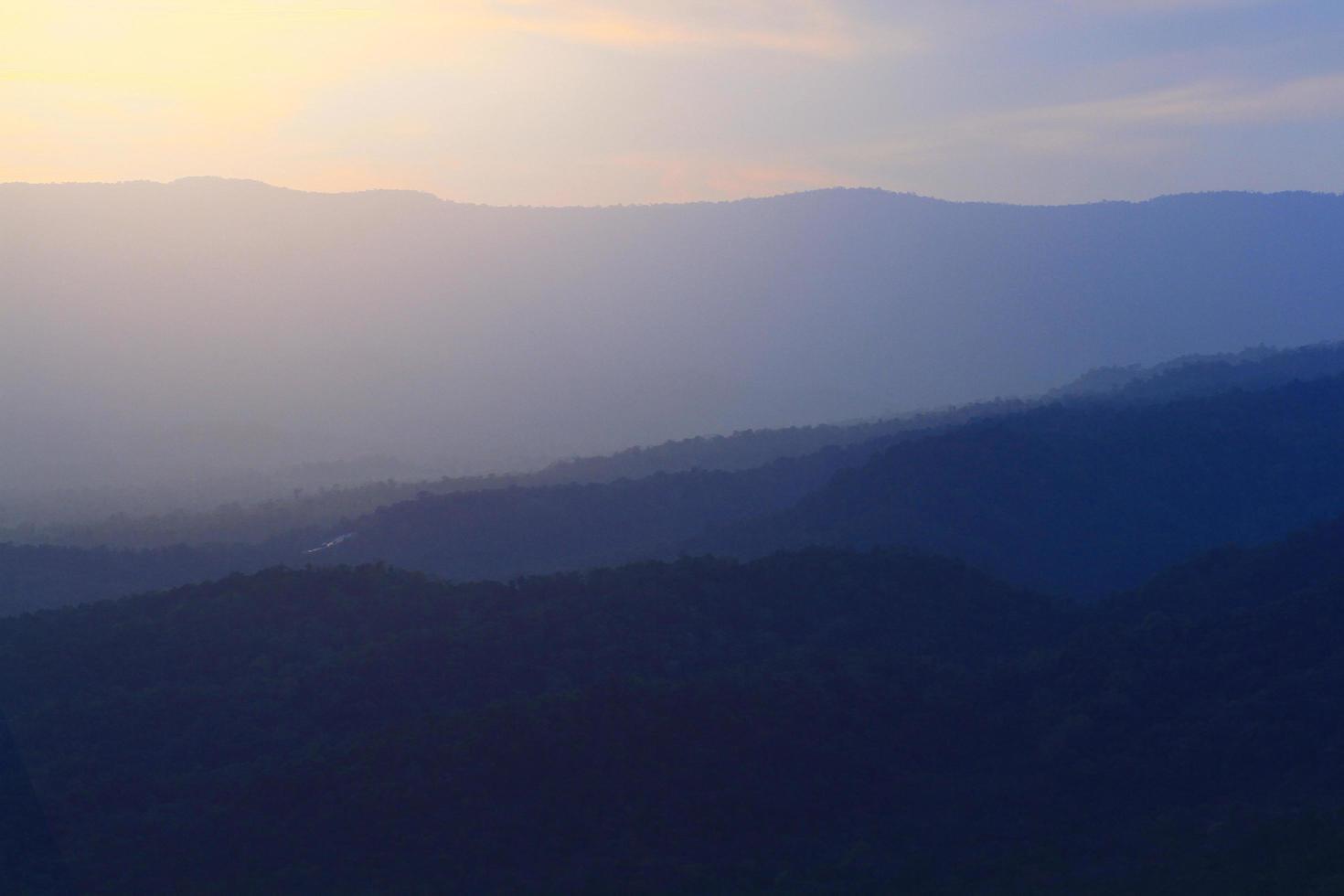 Beautiful landscape layers of mountain and Misty on hill valley in golden twilight of sunset at Thailand photo