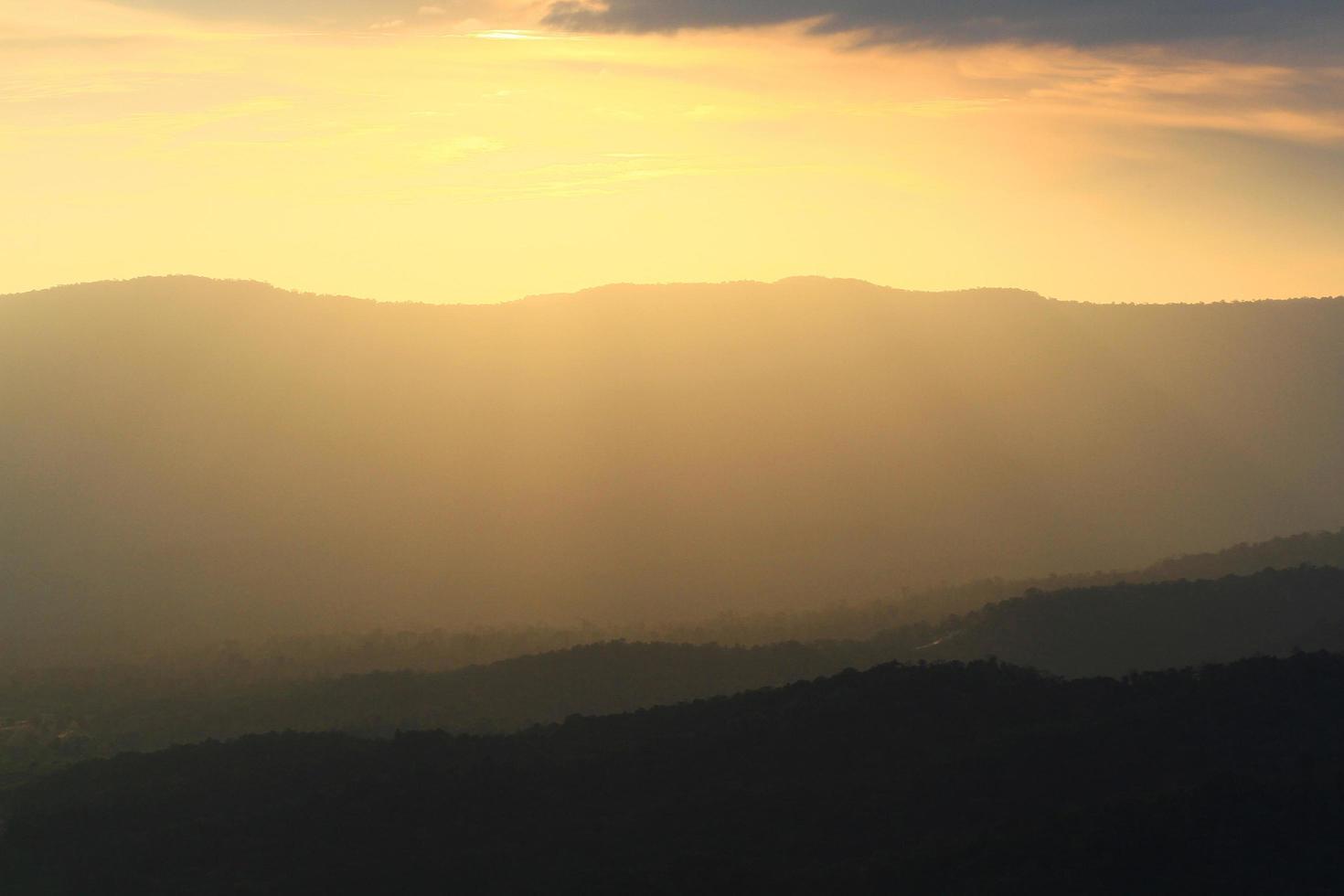 Beautiful landscape layers of mountain and Misty on hill valley in golden twilight of sunset at Thailand photo