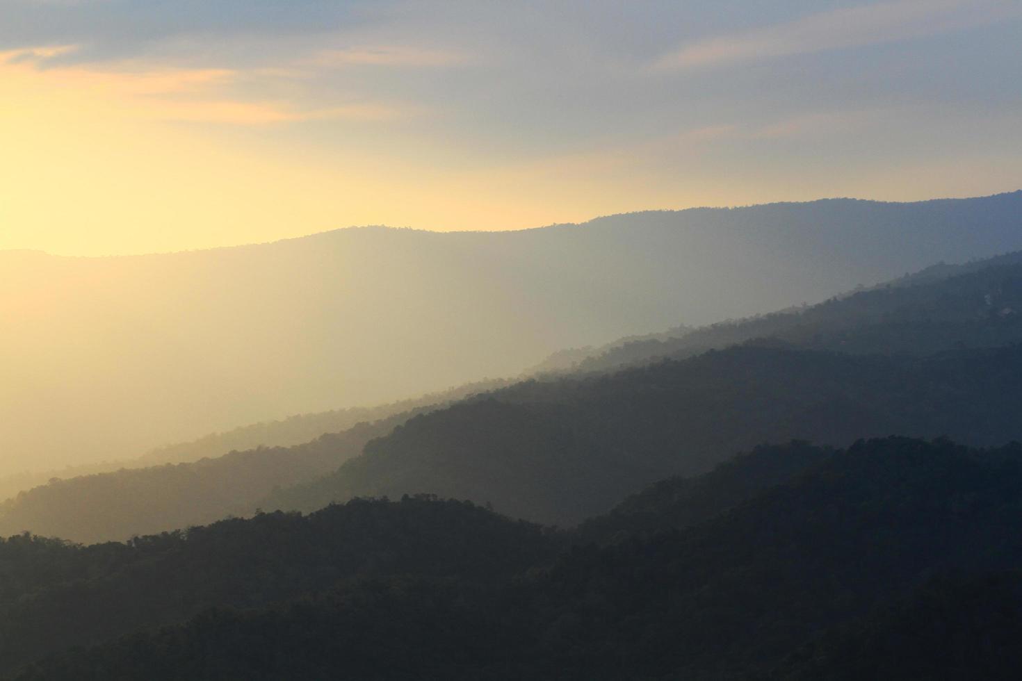 Beautiful landscape layers of mountain and Misty on hill valley in golden twilight of sunset at Thailand photo