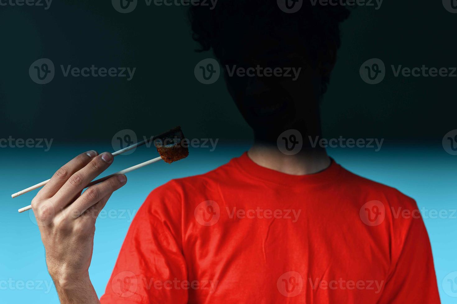 Man eating sushi photo