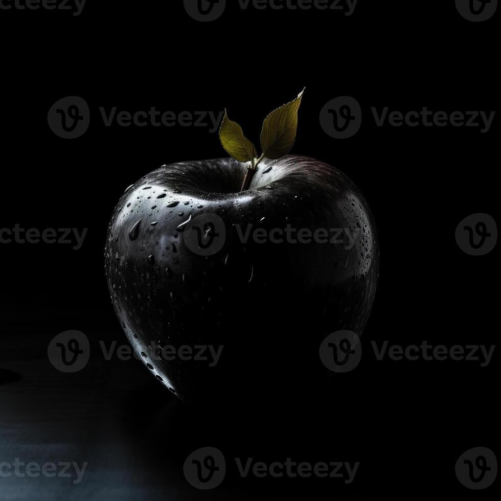 A fresh black apple on black background photo