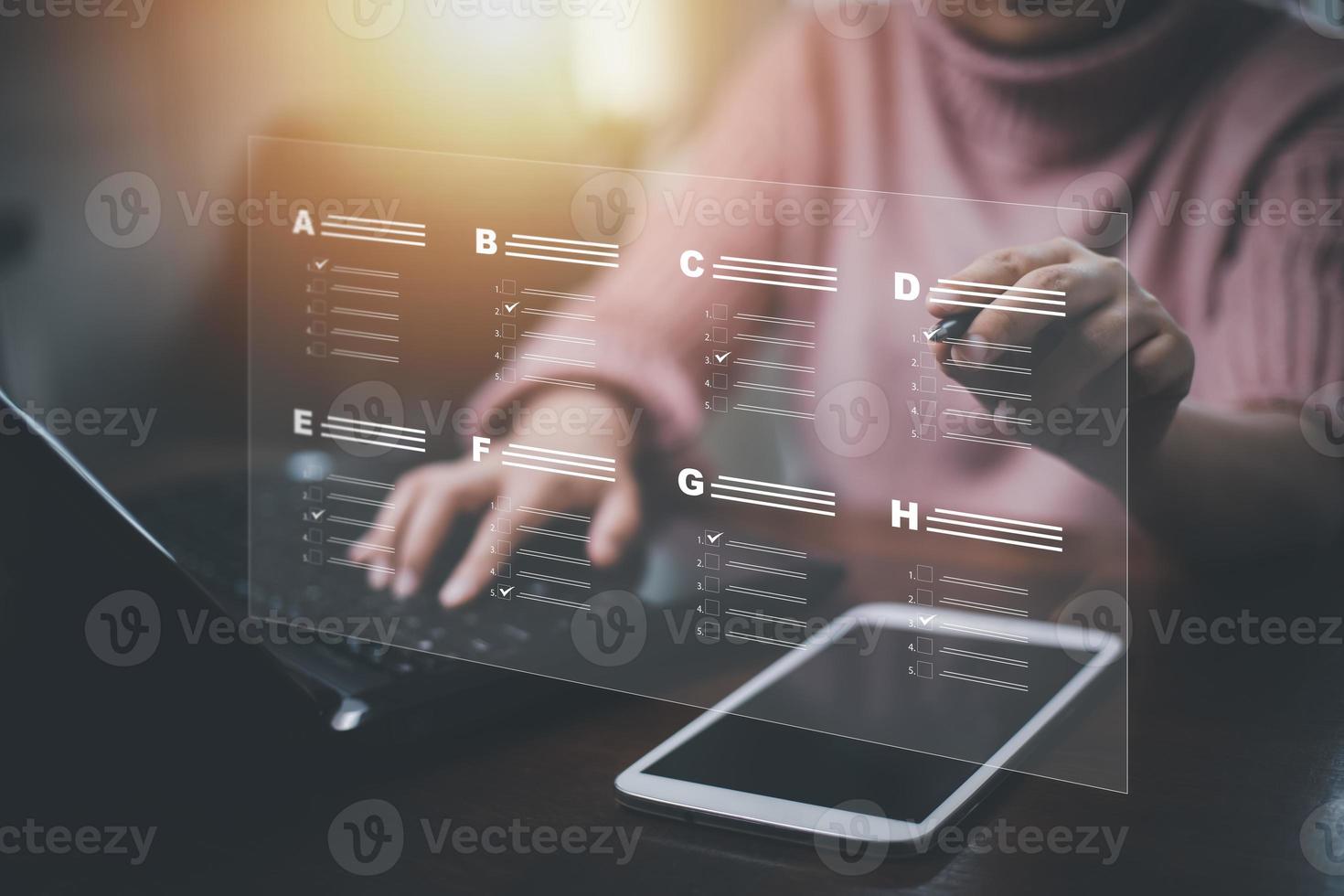 Businessman using a laptop and Taking an assessment, questionnaire, evaluation, online survey online exam Choosing the right answer in exam by filling out the online survey form,Answer  test questions photo