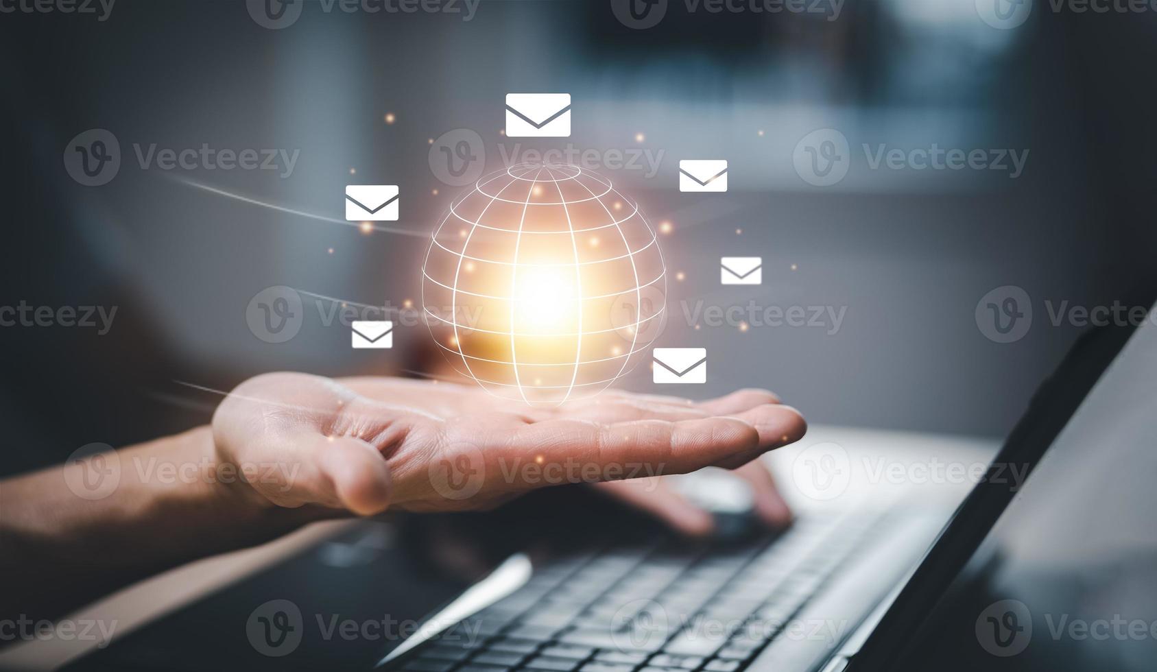 Business people hold a virtual world with communication icons, letter icons, email icons, and newsletter email and protect your personal information or spam mail, Customer service call center contact. photo