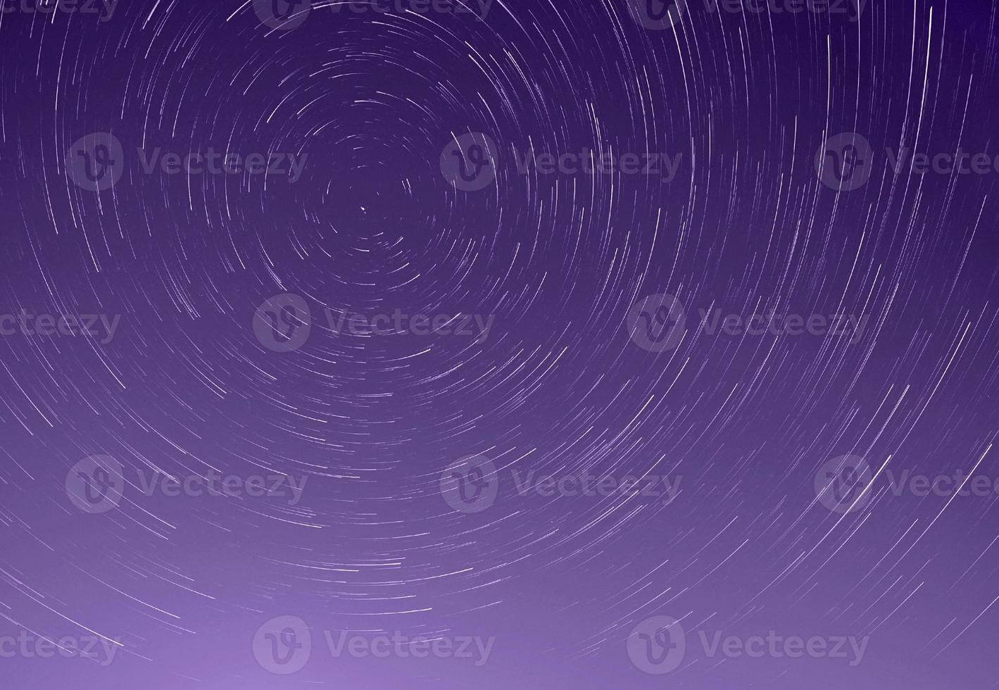 trails of stars in night sky photo