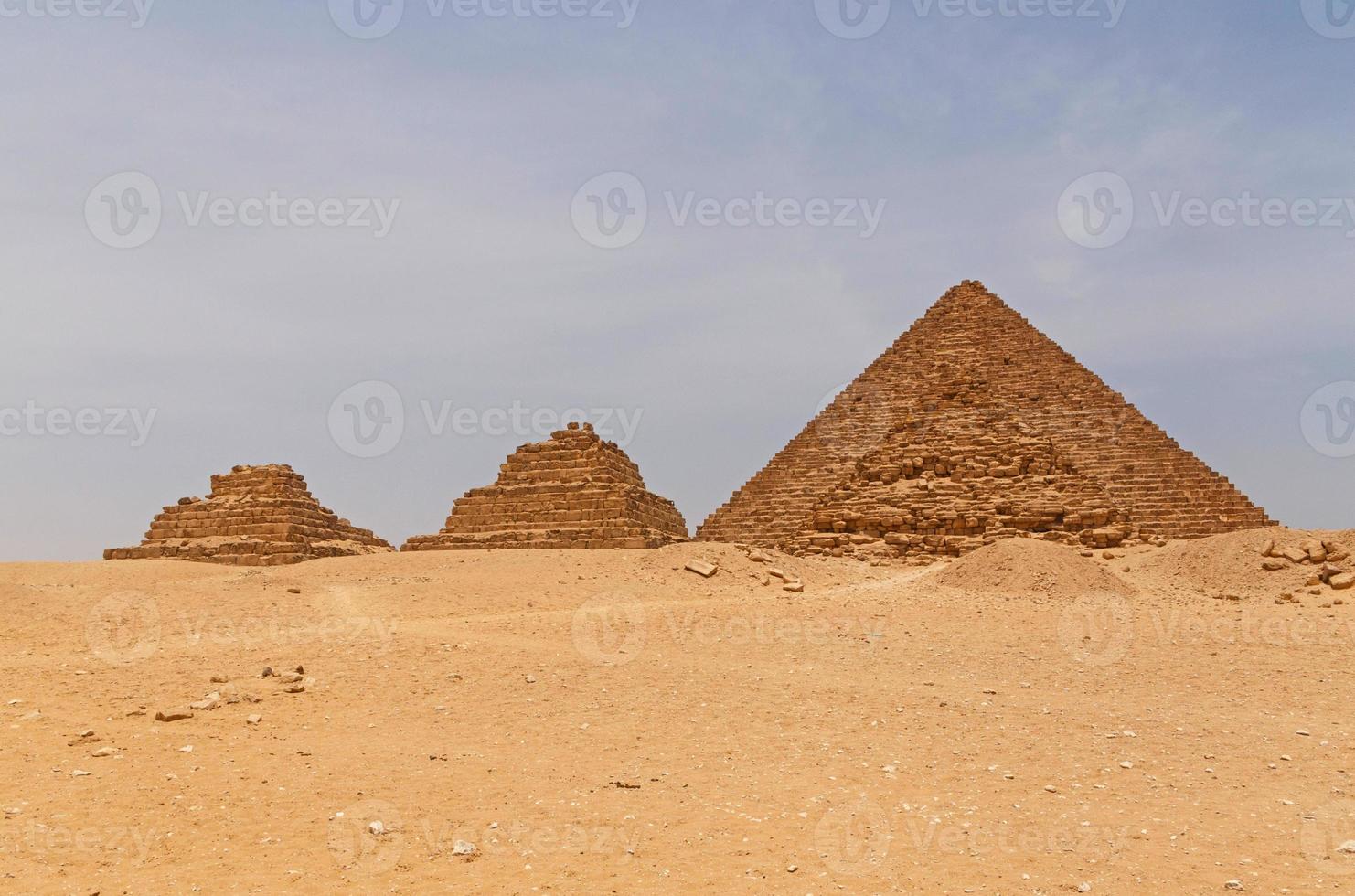 Pyramids of Queens in front of pyramid of Menkaure in Giza, Egypt photo