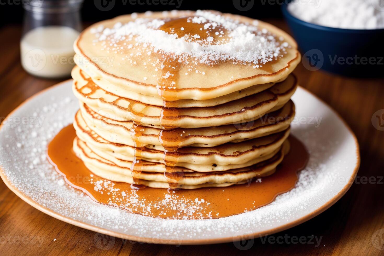 Stack of pancakes with maple syrup and sugar powder on a white plate. strawberries and whipped cream, photo