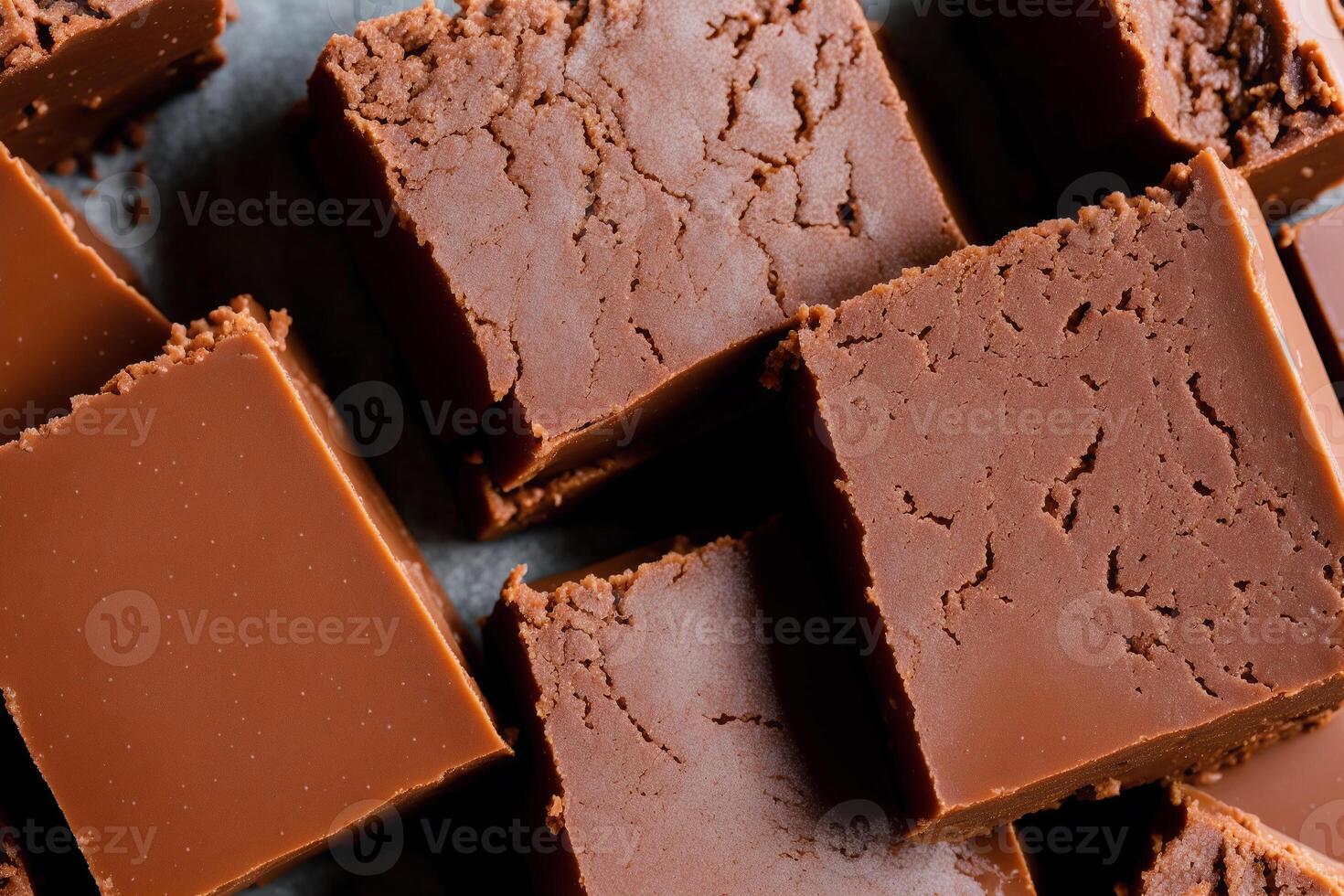 Fudge on a white plate on a wooden table. Homemade fudge cookies, candies with nuts. photo