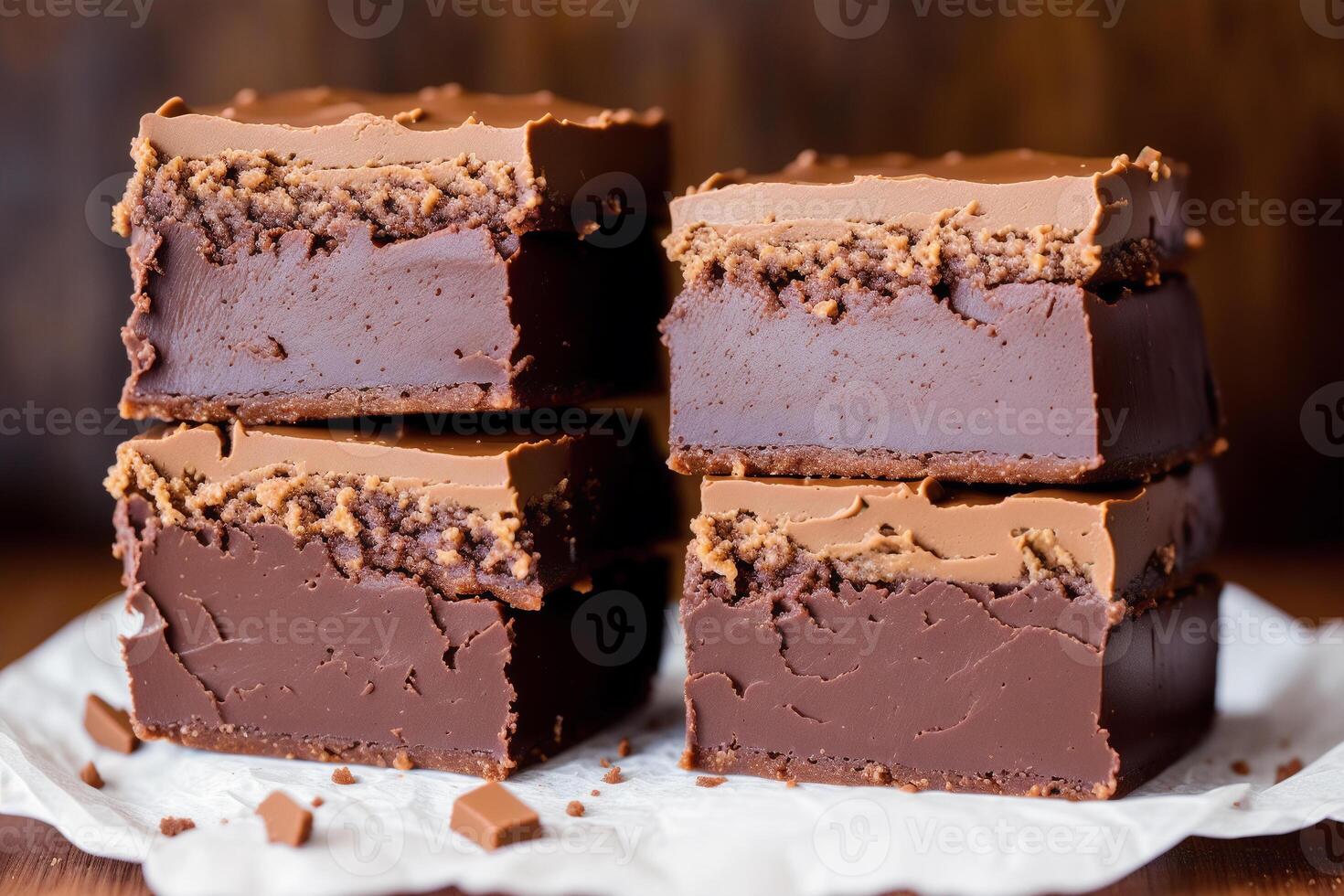 Fudge on a white plate on a wooden table. Homemade fudge cookies, candies with nuts. photo