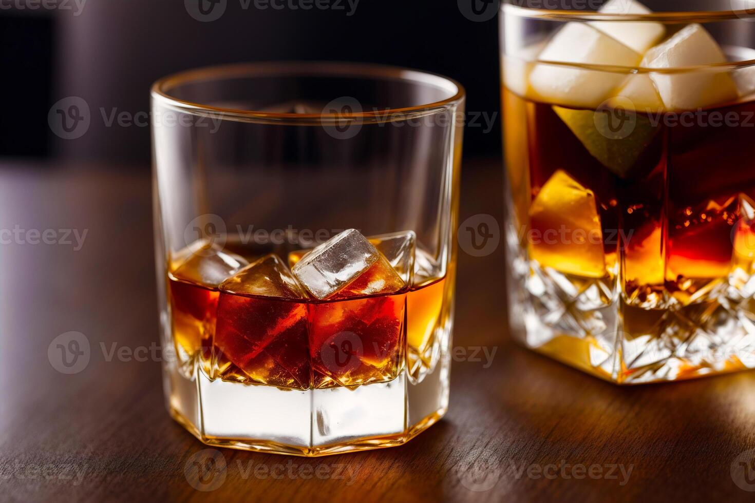 Glass of whiskey on the rocks with ice cubes on a wooden table, close-up. photo