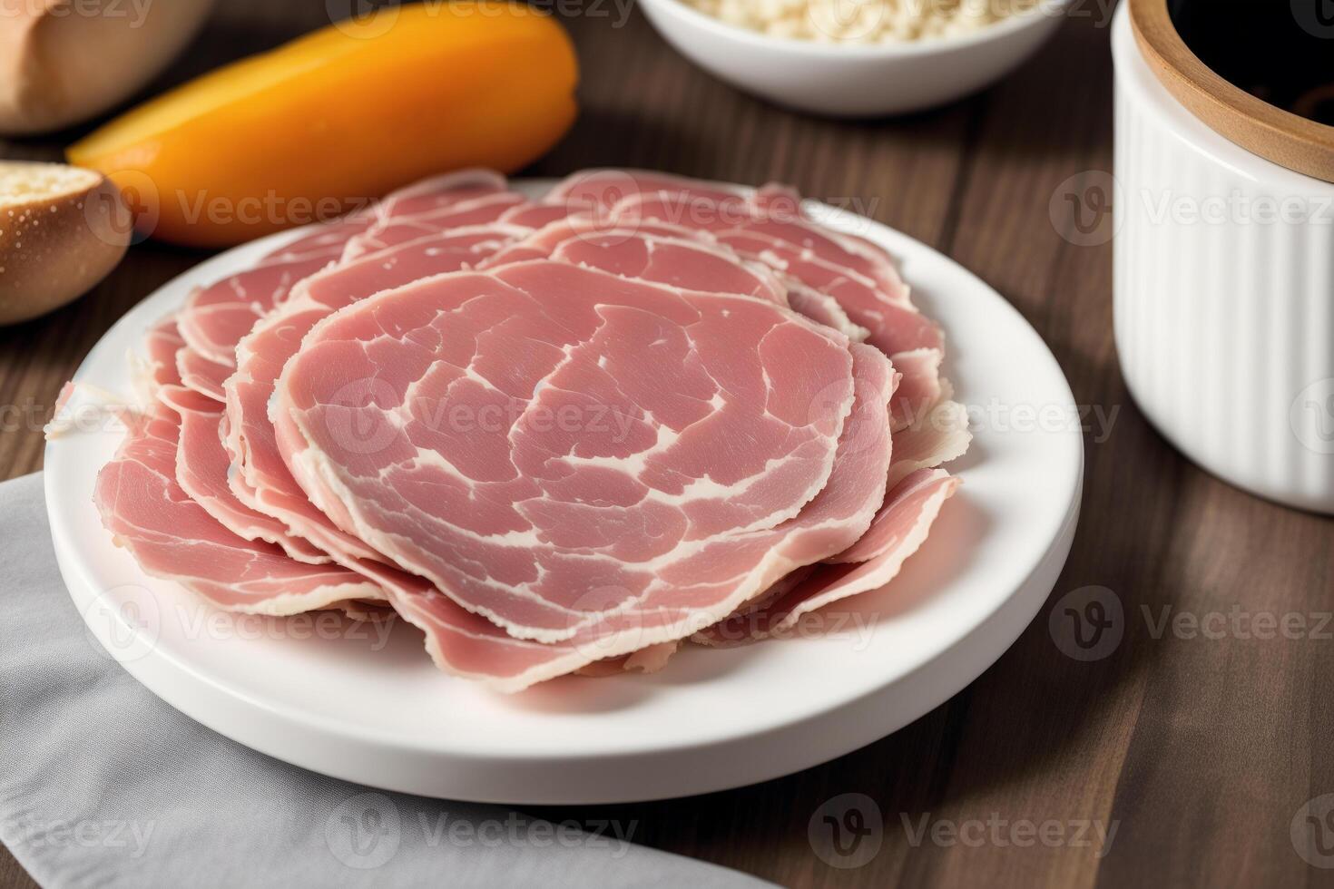 A plate of ham on the wooden table. photo