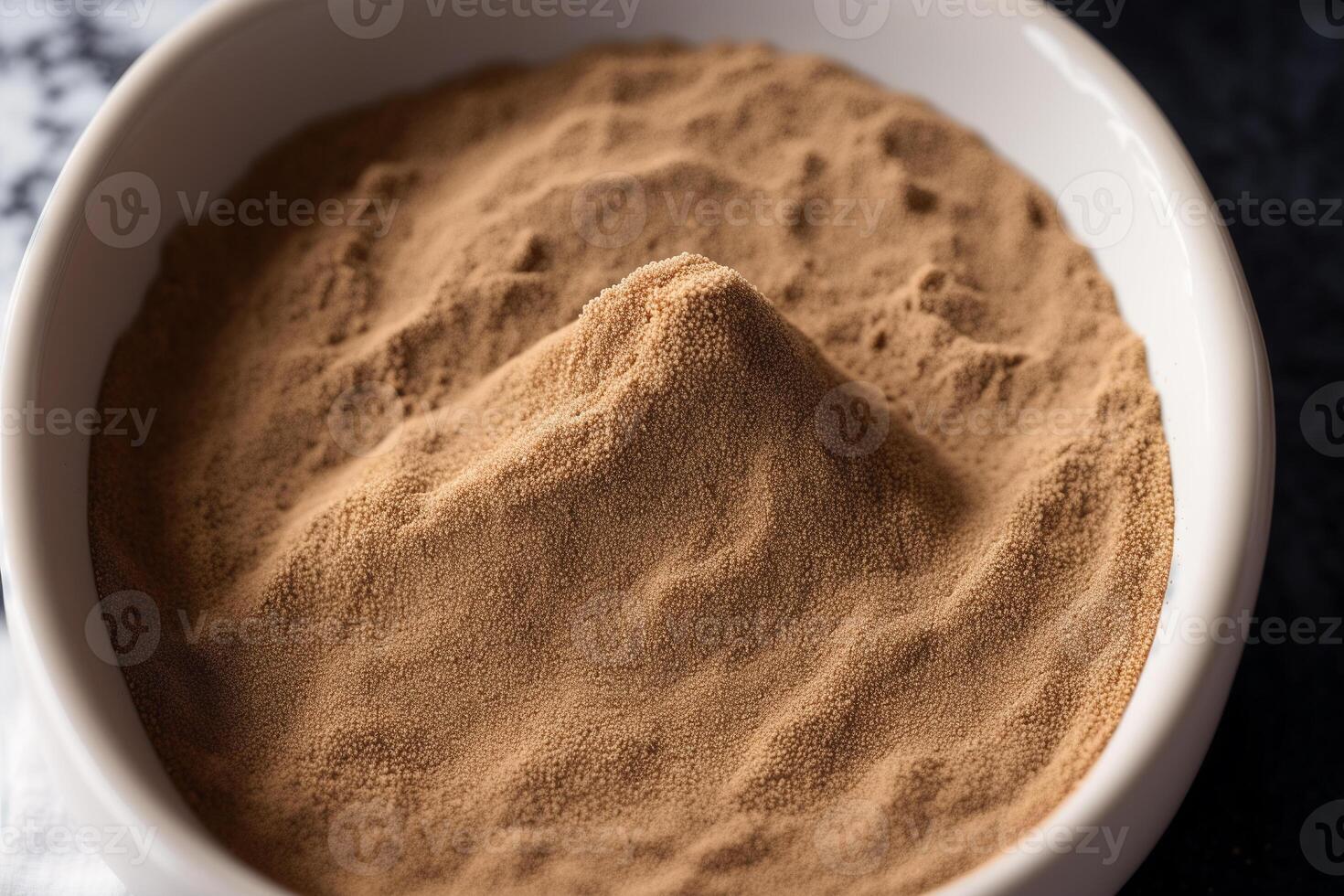 Cocoa Powder in a white bowl on a dark background. photo
