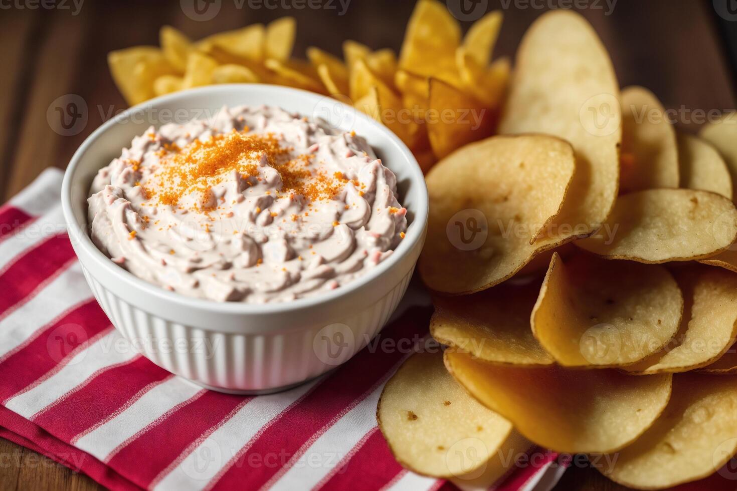 Potato chips in a bowl on a wooden background. photo