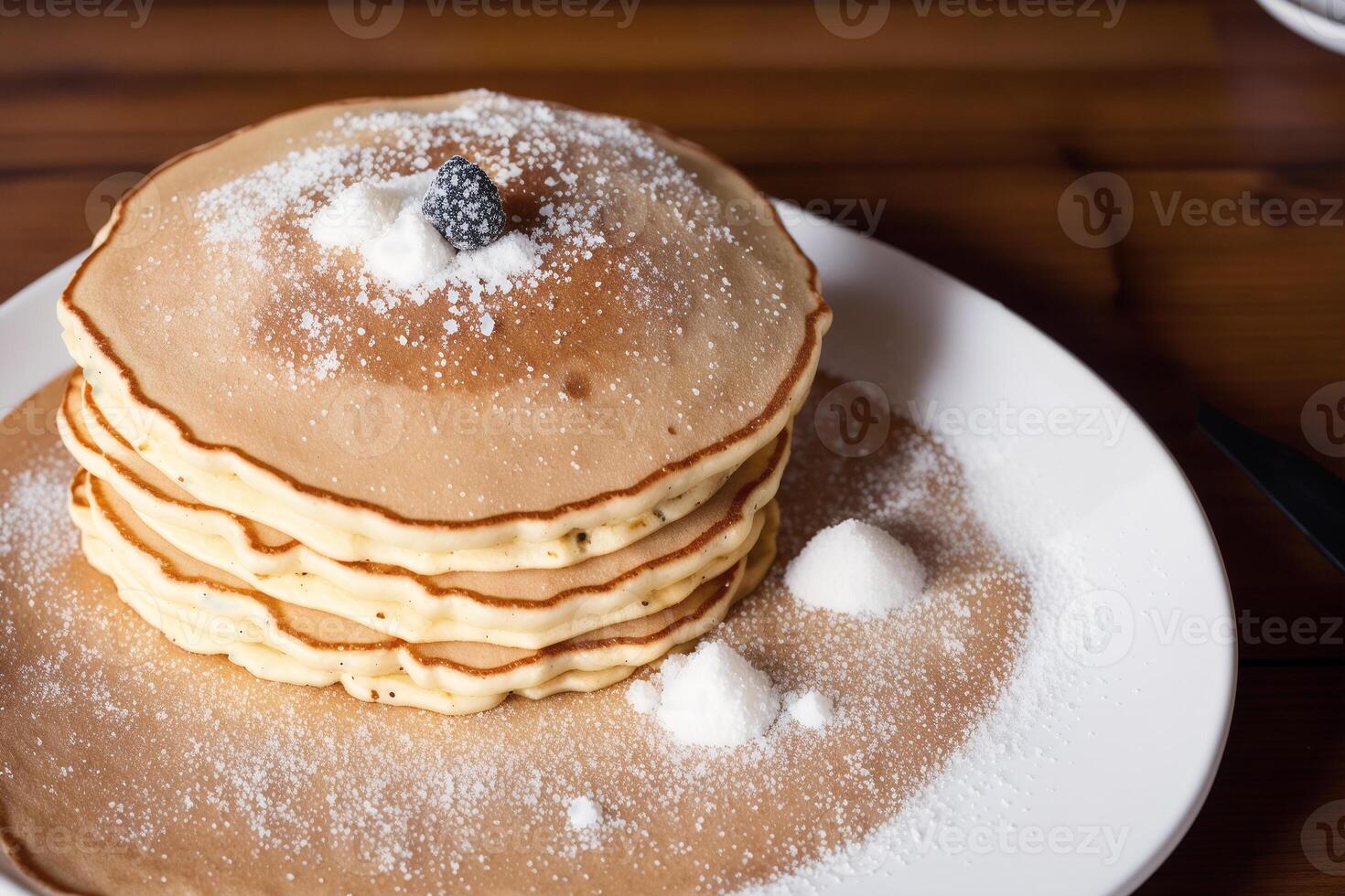 Stack of pancakes with maple syrup and sugar powder on a white plate. strawberries and whipped cream, photo
