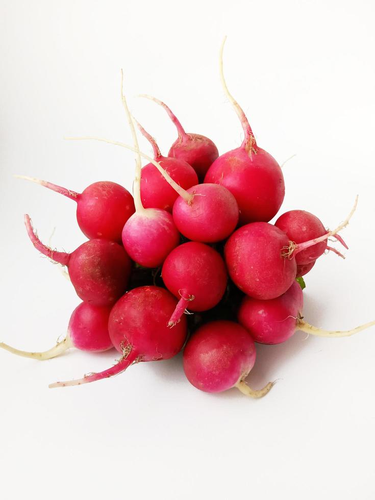 bunch of fresh radishes on white background photo