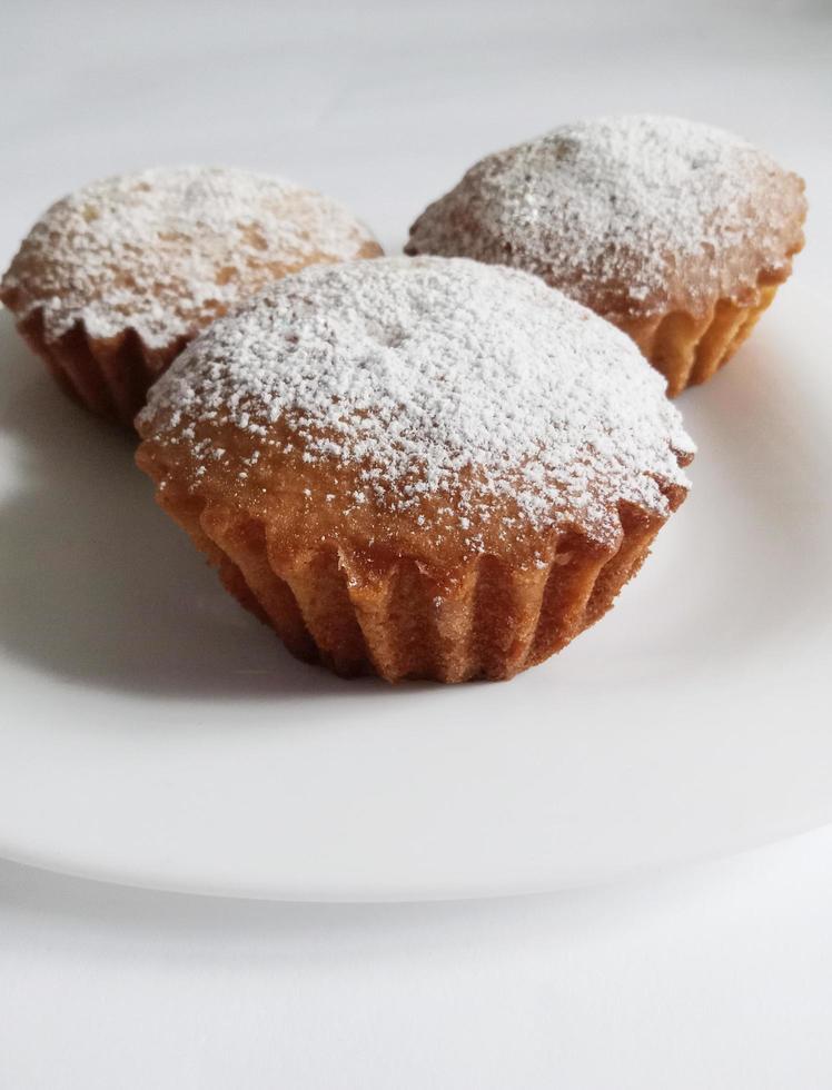 homemade cupcakes sprinkled with powdered sugar photo