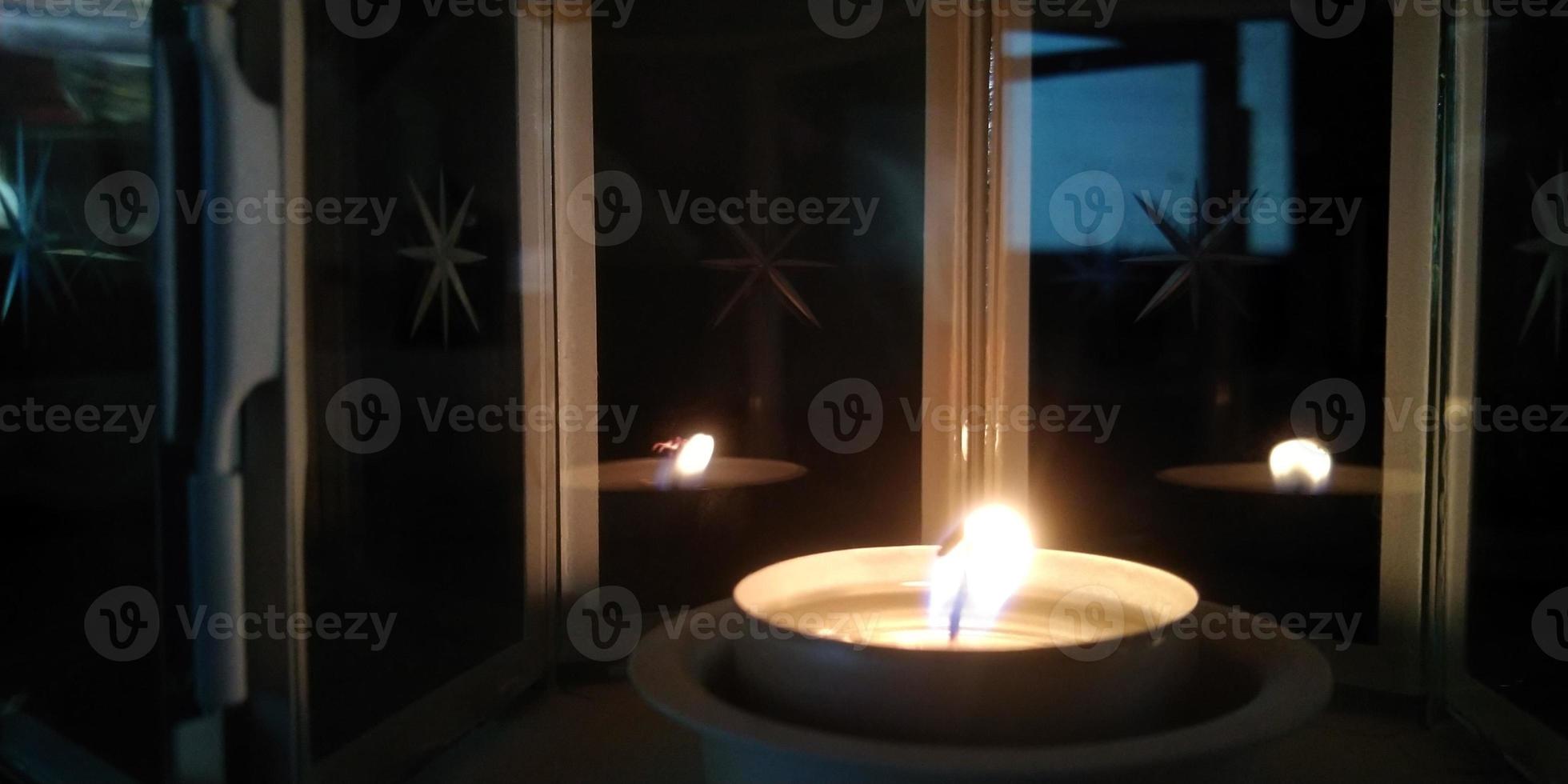 Blurred fire background. Burning candle closeup. photo